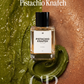 A clear rectangular perfume bottle labeled 'Pistachio Knafeh' with a black cap, centered over a split background of green paste on the left and copper-brown paste on the right. Large white text at the top reads 'Pistachio Knafeh,' and 'GP' and 'NOAH' appear as branding marks.