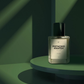 A clear glass perfume bottle with a black cap and a white label reading 'PISTACHIO KNAFEH' by the brand 'UP', set on a green tiered platform with dramatic green shadows.